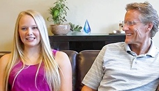 Smiling father and daughter at dental office