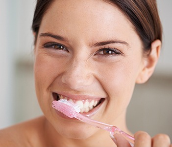 Woman brushing teeth