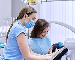 A woman consulting her dentist about treatment costs