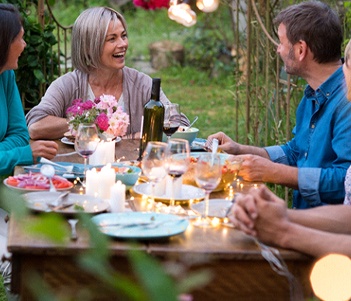 Woman with dentures in Vero smiling at dinner party