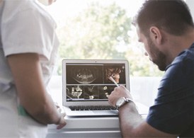 dentist looking at impressions of a mouth