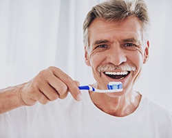 Man brushing teeth to prevent dental emergency in Vero Beach 