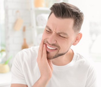 Man in white shirt with tooth pain