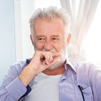 Man covering his smile