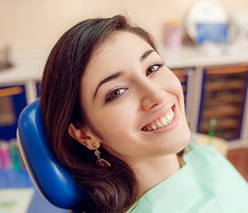 Woman in dental chair smiling