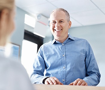 Man checking in at reception desk