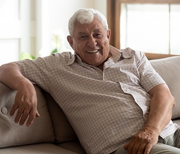 smiling person lounging on a couch