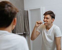 person brushing their teeth in a bathroom