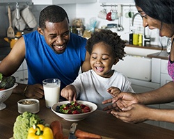 a family cooking a healthy meal together in a kitchen