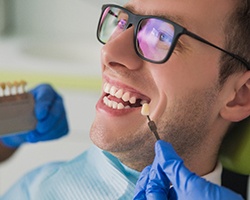 A young man with a missing tooth preparing to receive dental implants in Vero Beach