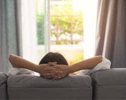 Woman relaxing at home after dental implant surgery in Vero Beach, FL