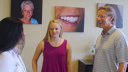 Father and daughter talking to their dentist in Vero Beach