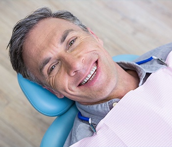 Man in dental chair smiling