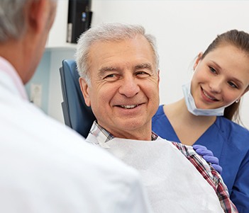 Older man in dental chair smiling