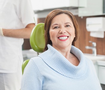 Older woman in dental chair smiling