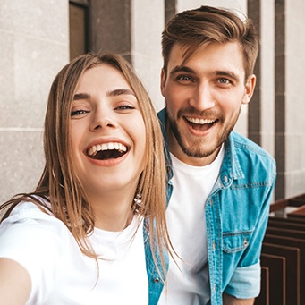Young couple with beautiful, well-shaped teeth taking selfie
