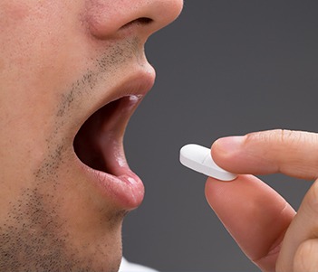 Patient taking oral sedative pill