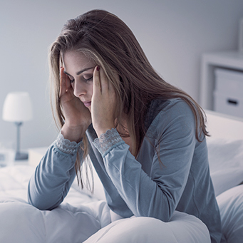 Woman with headache holding head