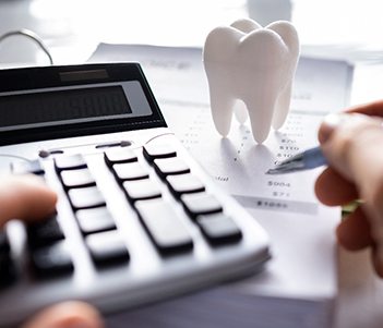 A patient calculating the cost of veneers