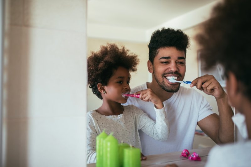 parent and child brushing their teeth