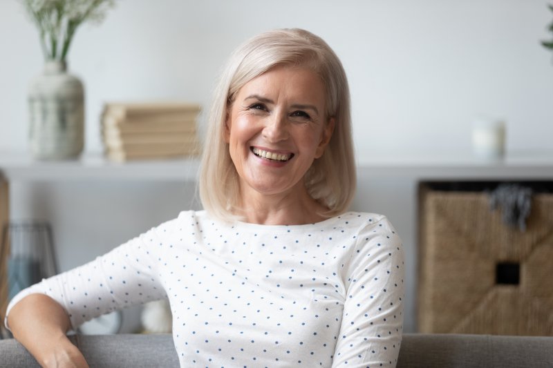 Older woman at home, smiling after teeth in a day