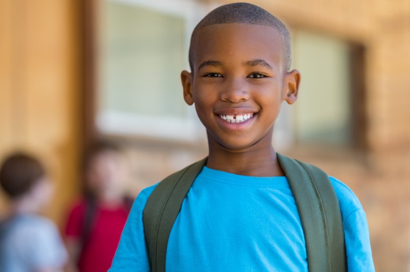 Young boy smiling on first day of school