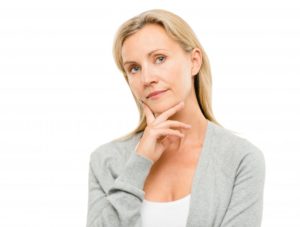 woman wondering how to find the best implant dentist