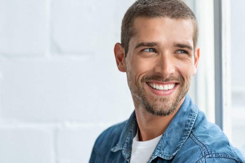 man with dental implant smiling