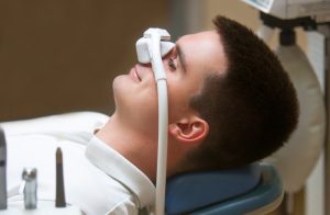 Patient taking nitrous oxide (laughing gas).