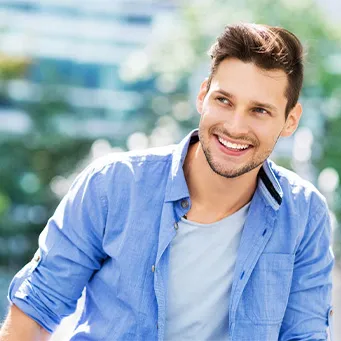 Smiling man in a light blue shirt